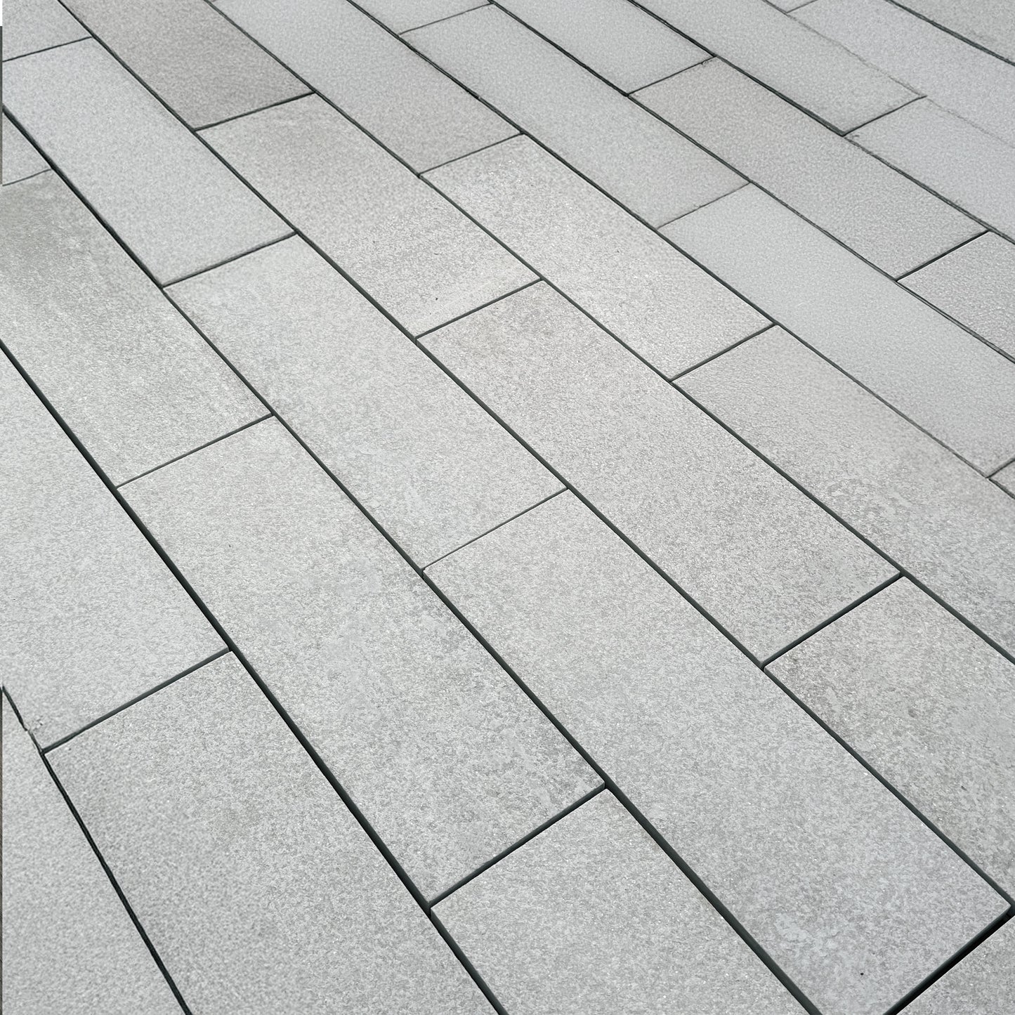 Sleek and sophisticated quartzite garden pavers adding texture and depth to an outdoor space, creating a refined, nature-inspired patio design.