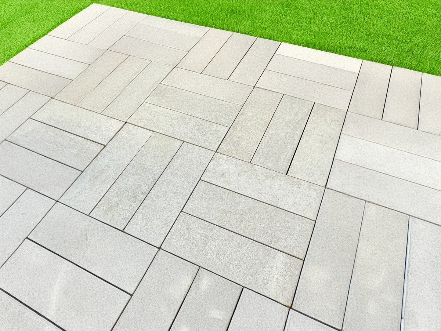 High-end quartzite stone pavers installed in a serene garden walkway, offering a natural yet refined look for upscale landscape design.