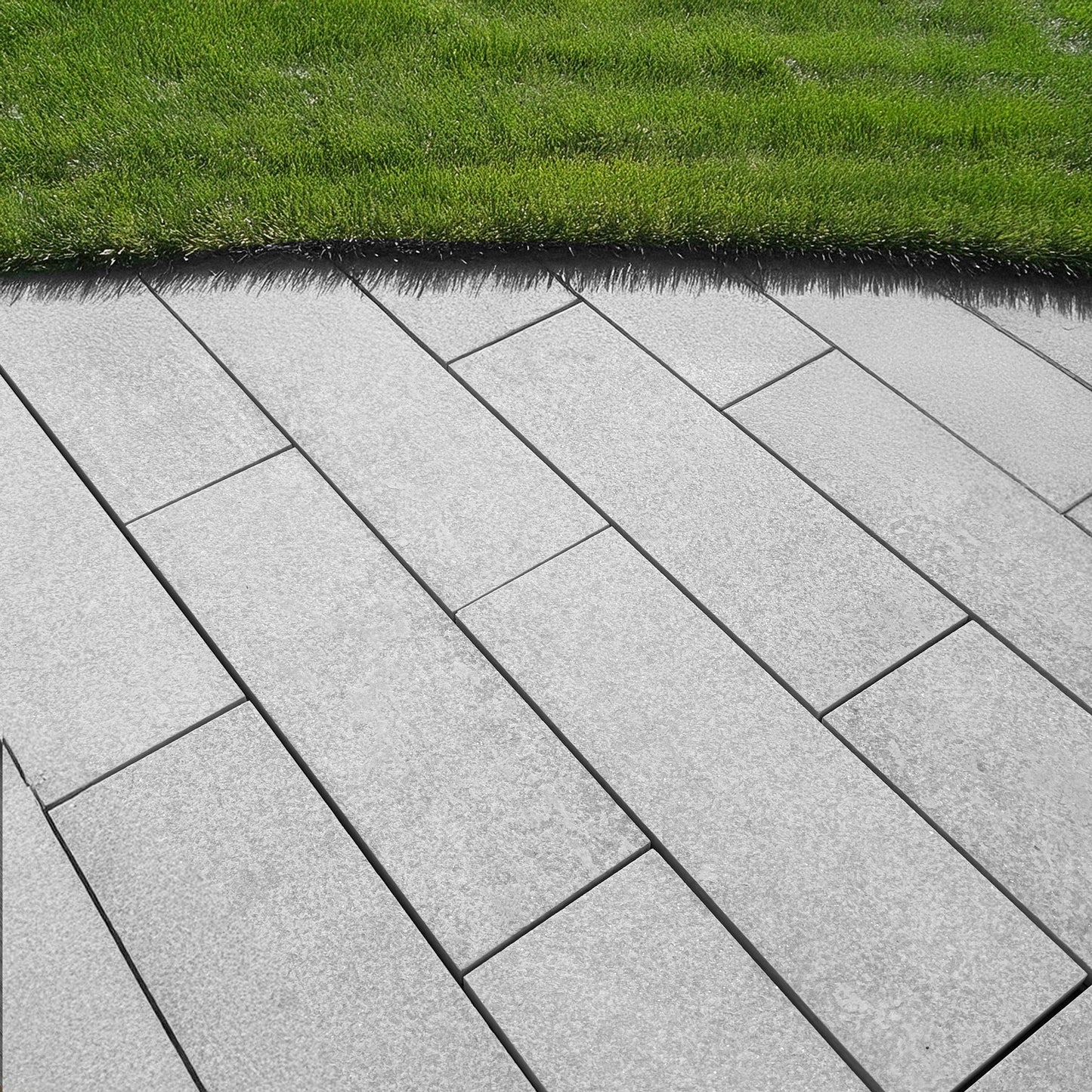 luxury quartzite pavers in an elegant, neutral color palette, seamlessly blending into a contemporary backyard with lush greenery and stylish decor.