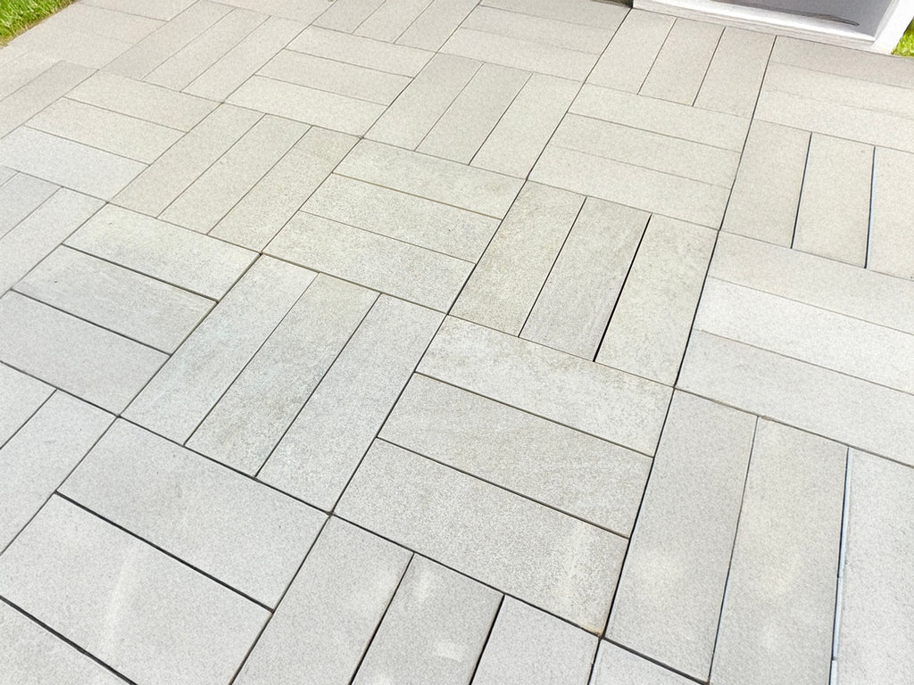 Luxury outdoor pavers crafted from solid quartzite, enhancing a backyard retreat with a seamless, natural stone surface perfect for foot traffic.