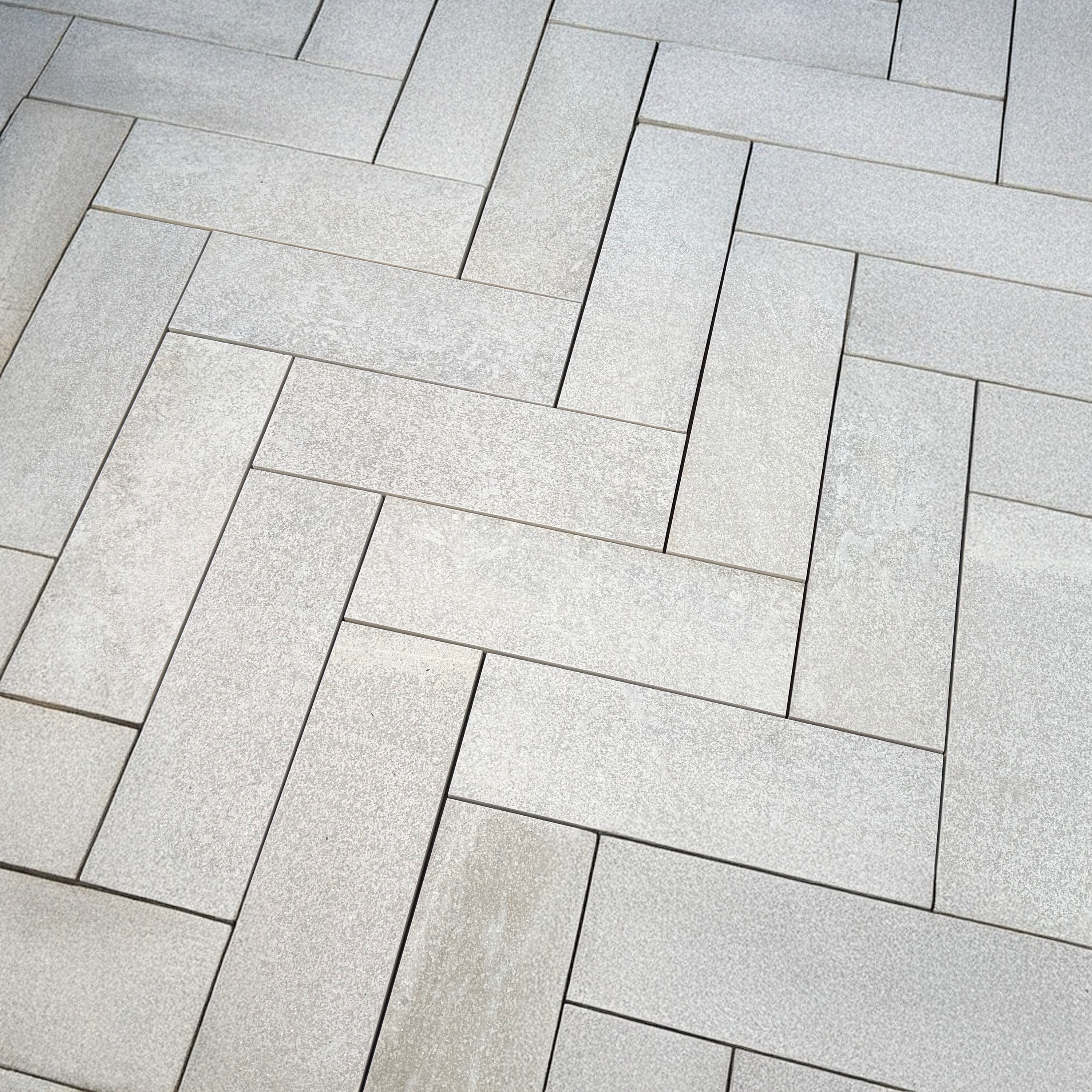Natural stone quartzite pavers with a textured surface, enhancing an outdoor space with their weather-resistant durability and timeless aesthetic.