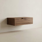 Wooden shelf mounted on a plain wall
